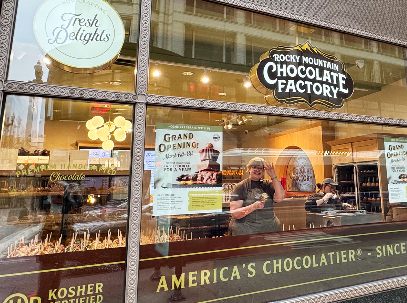 Chocolatiers creating caramel apples at Rocky Mountain Chocolate Factory in our new Chicago State St location